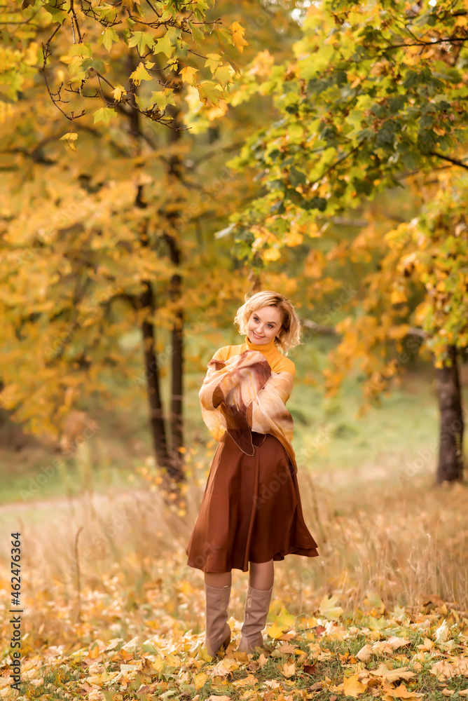 senior woman in an autumn park on a background of yellow leaves. senior woman in an autumn park on a background of yellow leaves.