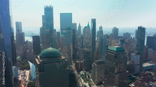 Drone flying backwards from business offices on lower Manhattan, World Trade center at ground zero memorial. Panoramic view on Wall street business district with banks buildings in New York city