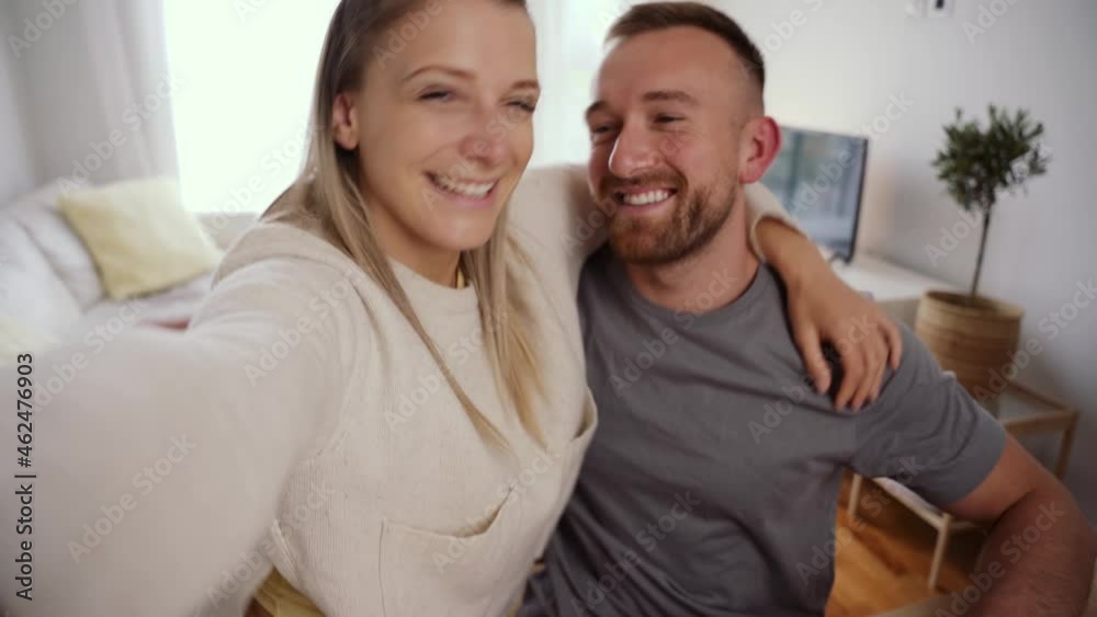 Happy caucasian female hugging boyfriend taking selfie on cellular device Happy caucasian female hugging boyfriend taking selfie on cellular device