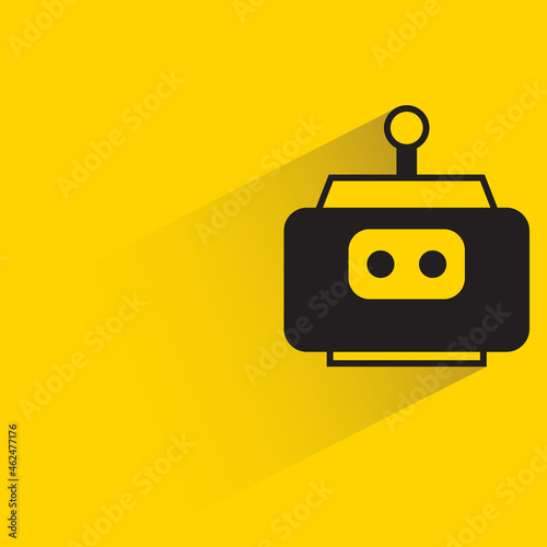 robot head with shadow on yellow background