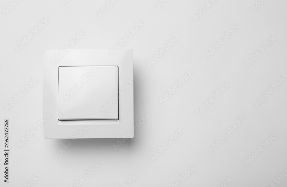 Modern plastic light switch on white background. Space for text Modern plastic light switch on white background. Space for text