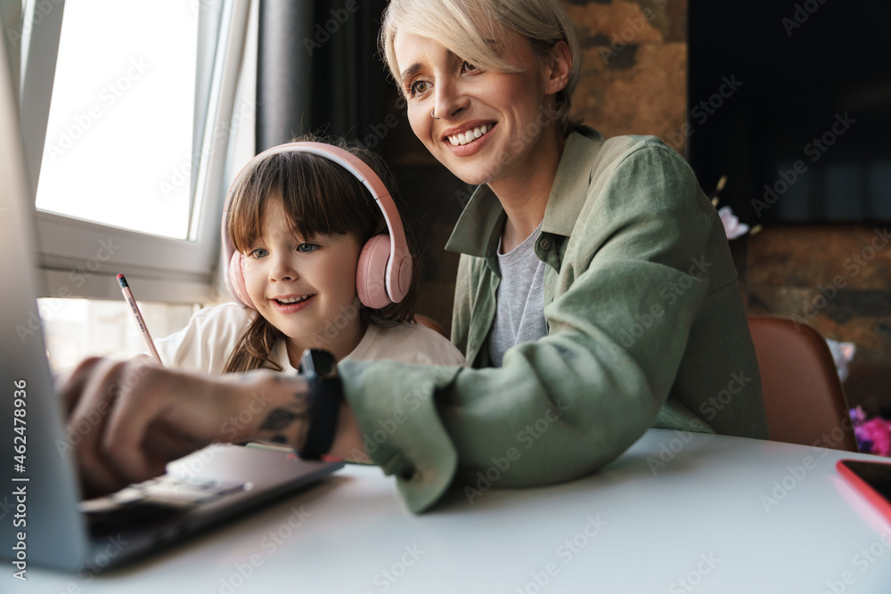 Mother helping her daughter with her homework Mother helping her daughter with her homework