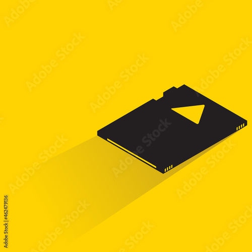 memory chip with shadow on yellow background