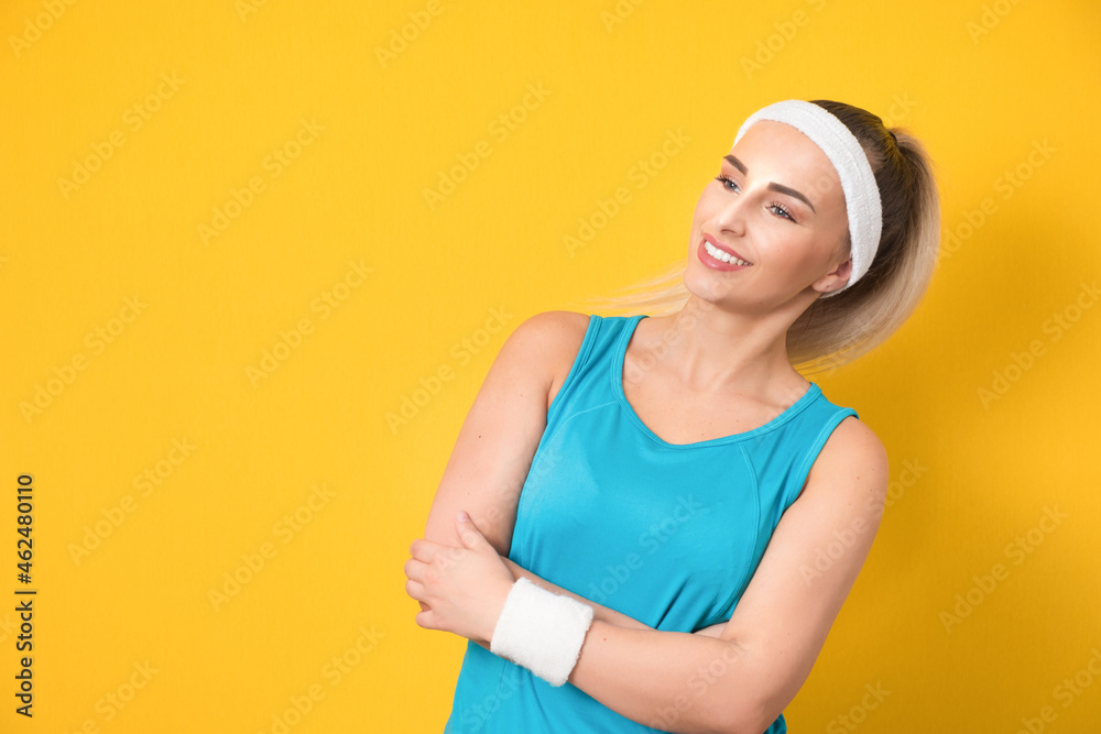 Pleasure fitness girl looking up and wearing sport clothing - sportswear, isolated on yellow background. Beautiful vitality woman with crossed arms standing. 80s styling Pleasure fitness girl looking up and wearing sport clothing - sportswear, isolated on yellow background. Beautiful vitality woman with crossed arms standing. 80s styling