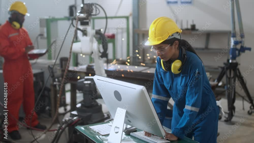 specialist technical engineer hand input programing code data computing to manage movement work flow of robotarm welding machinery in workshop modern factory smart industrial manufacture concept