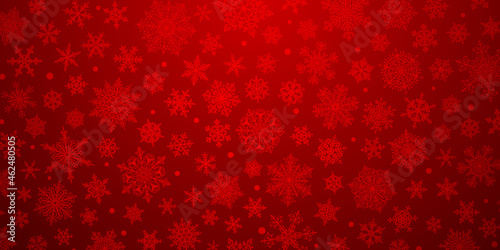 Christmas background of big and small complex snowflakes in red colors