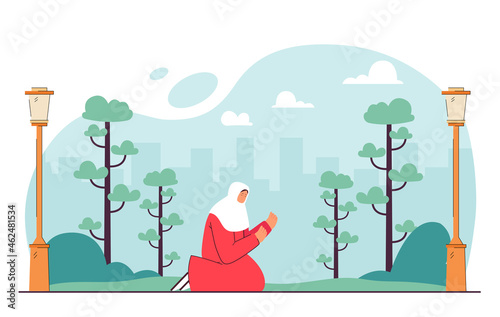 Cartoon Muslim woman praying in city park. Islamic female character on knees outside flat vector illustration. Religion, faith, culture, Ramadan concept for banner, website design or landing web page