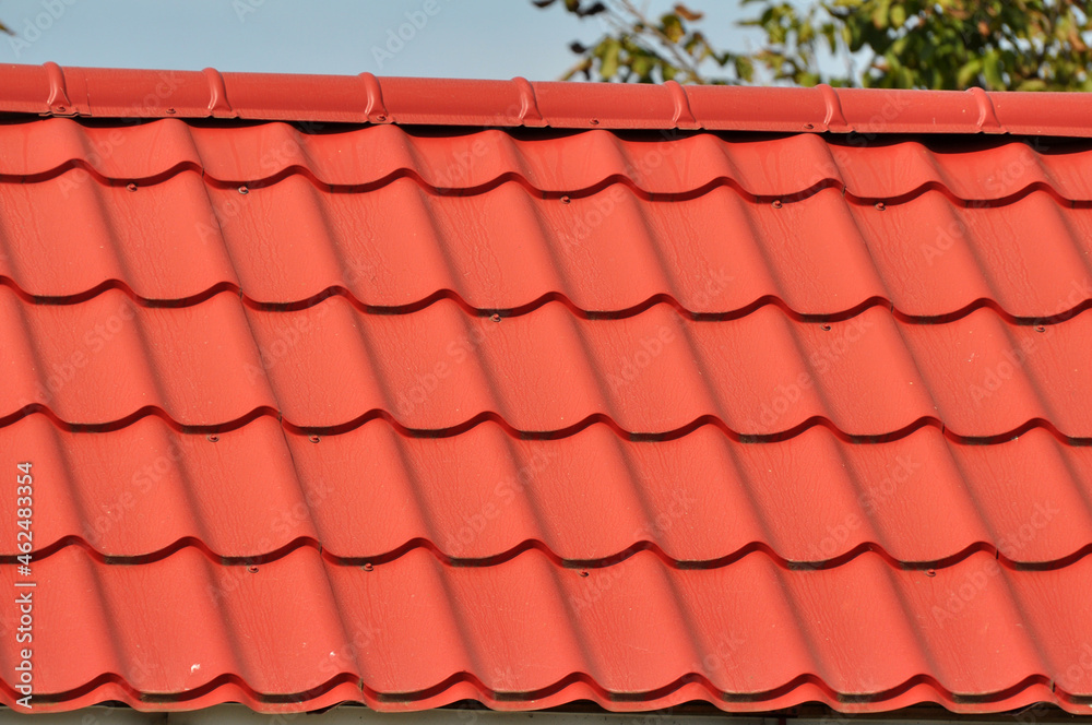 The roof of the house is covered with metal tiles The roof of the house is covered with metal tiles