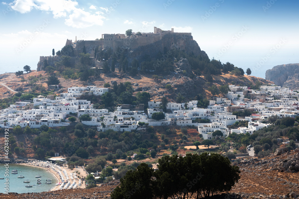 Panoramic view of the old town of Lindos in Greece with the acropolis on top of the hill.