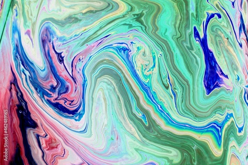 Abstract turquoise marble background. Acrylic paint mixes freely and creates an interesting pattern. Bright saturated shades. Background for the cover of a laptop, laptop.