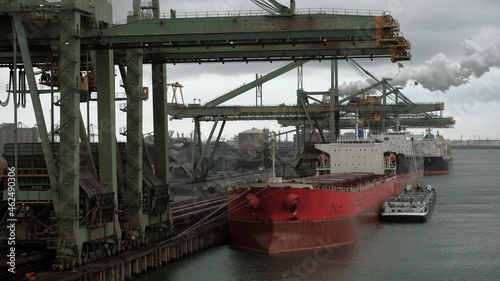 Red bulk carrier in the port of Rotterdam photo