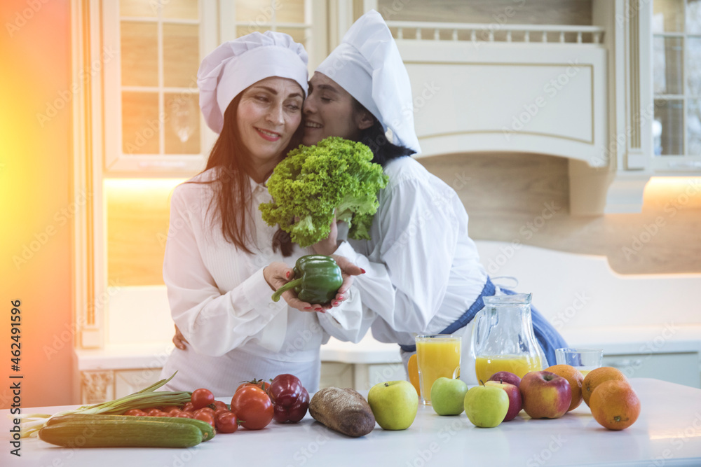 Two cheerful friends cook together. Friends Chef Cook Cooking Concept.
Two cheerful friends cook together. Friends Chef Cook Cooking Concept.