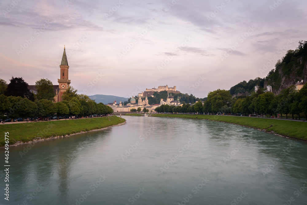 Panoramic view of Salzburg skyline with river Salzach in summertime at sunset, Austria