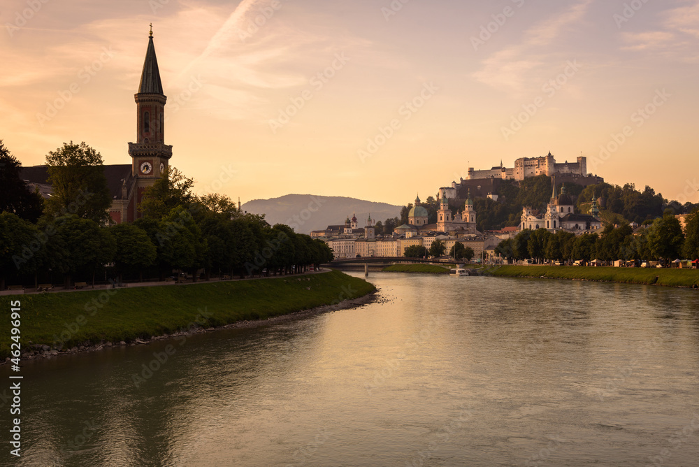 Panoramic view of Salzburg skyline with river Salzach in summertime at sunrise, Austria