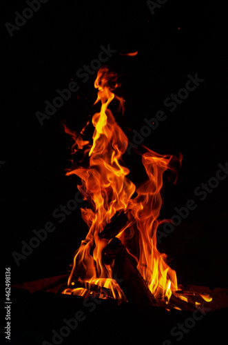 fire with a yellow orange flame on a black background isolate