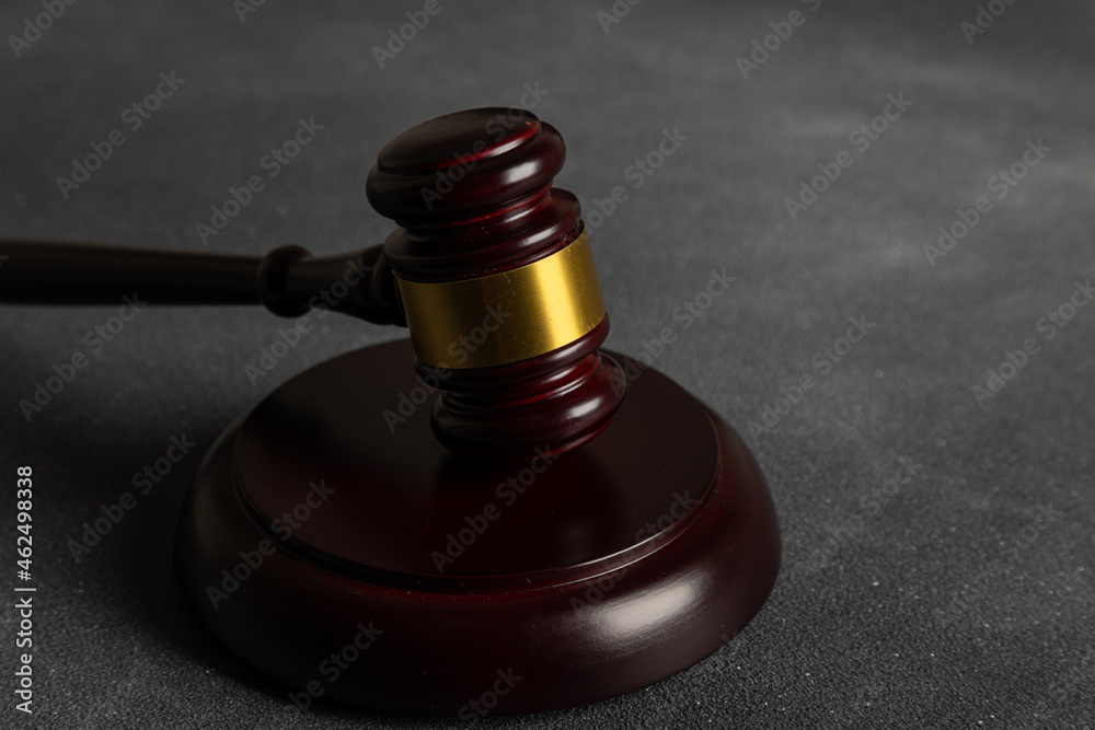 Law theme, mallet of the judge on wooden desk with Lady Justice Statue. Law gavel on dark foggy background with light. Law theme, mallet of the judge on wooden desk with Lady Justice Statue. Law gavel on dark foggy background with light.