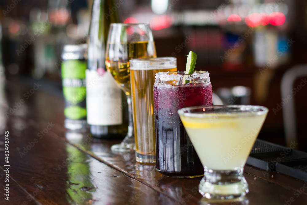 Cocktails lined up on the bar countertop Cocktails lined up on the bar countertop