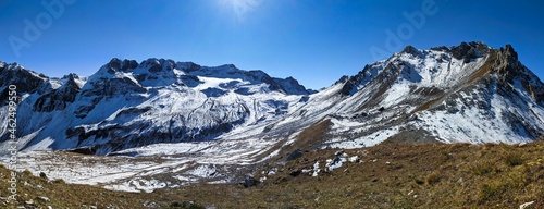 Snowy mountain landscape on the shady side. Hike above Sertig Davos. Ducan Glacier. Switzerland. Large peak panorama © SimonMichael