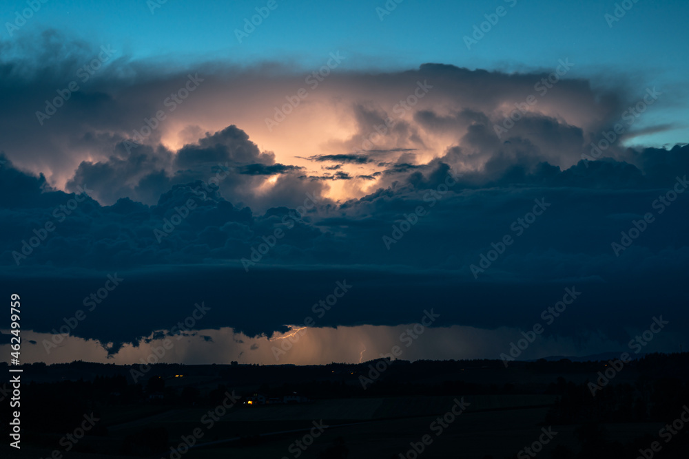 Dramatic looking lightning storm at the border of Austria and Germany during blue hour