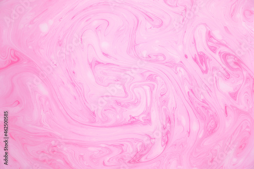 Abstract colored marble background, stains of pink paint on the surface of the water. Liquid colorful backdrop.