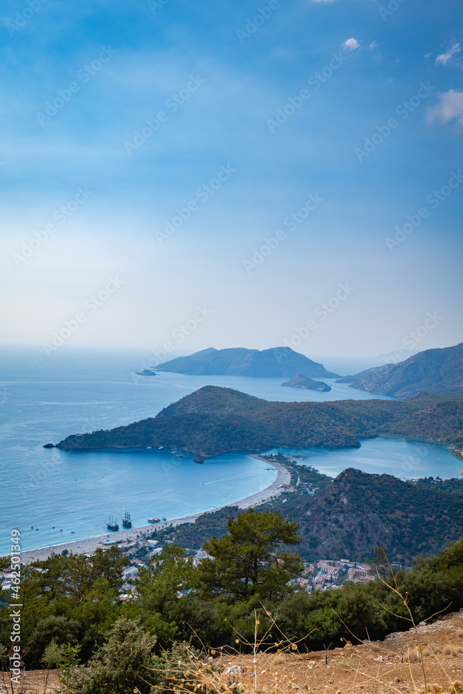 Oludeniz blue lagoon and sand beach in Fethiye, Turkey. Turquoise Coast of southwestern Turkey, taken on Lycian way hiking track on sunny bright day with blue sky in Oludeniz. Oludeniz blue lagoon and sand beach in Fethiye, Turkey. Turquoise Coast of southwestern Turkey, taken on Lycian way hiking track on sunny bright day with blue sky in Oludeniz.