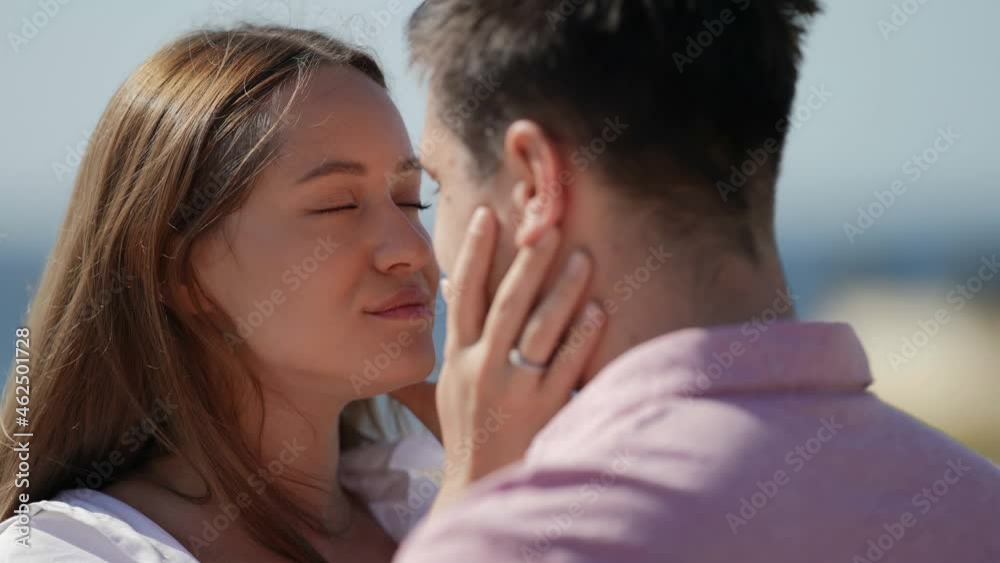 tender kiss of lovers outdoor in summer, young woman is kissing tenderly her boyfriend tender kiss of lovers outdoor in summer, young woman is kissing tenderly her boyfriend