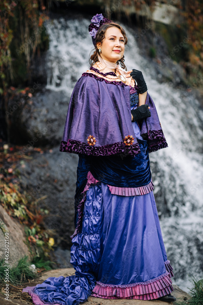 Women in costumes of the 19th century against the background of nature in the spring in the park