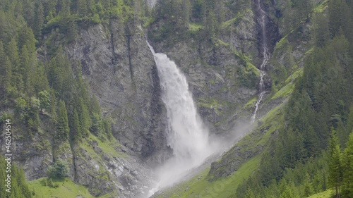 Waterfall in the mountains. Staeubifall, Staublifall powerful waterfall near Unterschächen, Klausenpass, Canton Uri, Switzerland. photo