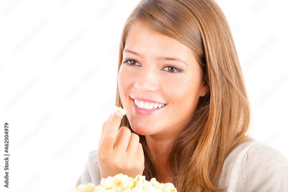 Beautiful teenager eating popcorn, studio shot, isolated on white Beautiful teenager eating popcorn, studio shot, isolated on white