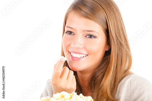 Beautiful teenager eating popcorn, studio shot, isolated on white