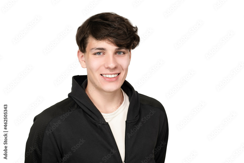 Teenager boy smiling beautifully on a white background, isolated. The guy has dark hair and white teeth. The teenager is dressed in a sports jacket with a hood Teenager boy smiling beautifully on a white background, isolated. The guy has dark hair and white teeth. The teenager is dressed in a sports jacket with a hood