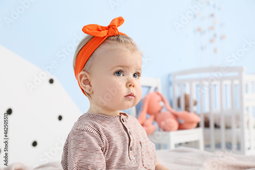 Adorable baby girl in bedroom