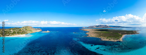 Fototapeta Naklejka Na Ścianę i Meble -  View from above, aerial shot, stunning panoramic view of La Pelosa Beach and the Asinara island bathed by a turquoise, crystal clear water. Spiaggia La Pelosa, Stintino, north-west Sardinia, Italy.