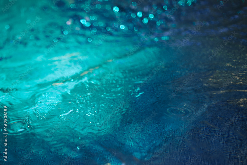 Obraz premium Water blue background with waves and lighting. Neon water texture