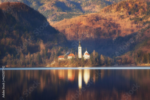 Obraz na płótnie Morning landscape on Lake Bled, Slovenia. Island against the backdrop of mountain slopes, autumnal view, soft light, postcard. Desktop wallpaper, cell phone wallpaper. w salonie