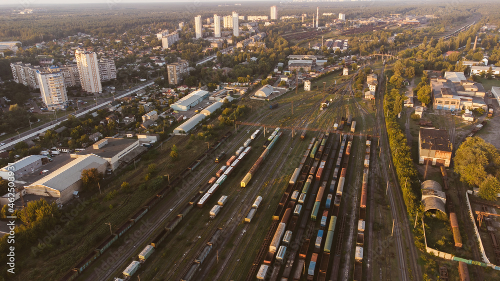 Fototapeta premium Aerial View. Old defective and looted railway wagons stand on the territory of the repair depot awaiting repairs. Poor business management. Ukrainian railway, DVRZ.