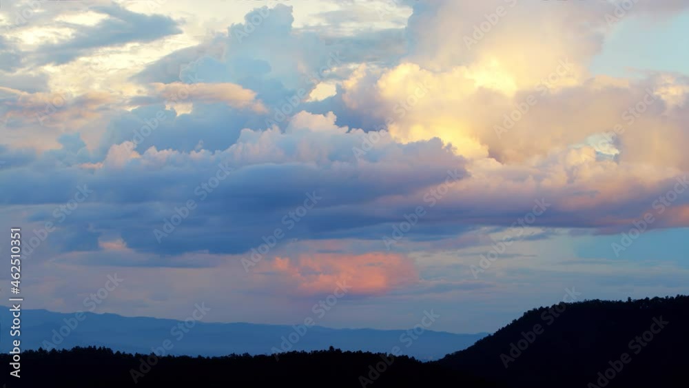 Magical blue and orange clouds swirl over the mountain at sunset. Timelapse, relaxation weather dramatic beauty atmosphere background Magical blue and orange clouds swirl over the mountain at sunset. Timelapse, relaxation weather dramatic beauty atmosphere background