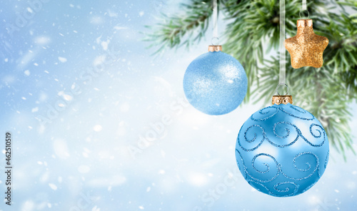christmas ornament and tree on light blue background