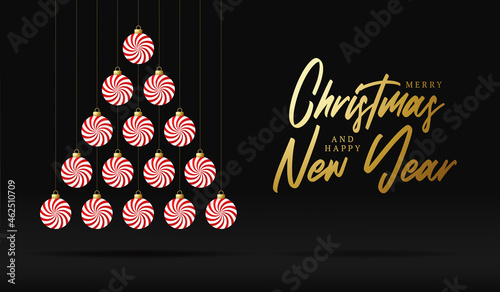 Creative sweet Xmas tree made mint candy bauble balls for Christmas and New Year celebration on luxury black background