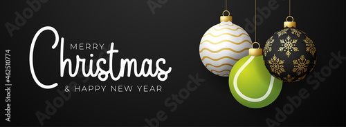 tennis Christmas card. Merry Christmas sport greeting card. Hang on a thread Tennis ball as a xmas ball and golden bauble on black horizontal background. Sport Vector illustration.
