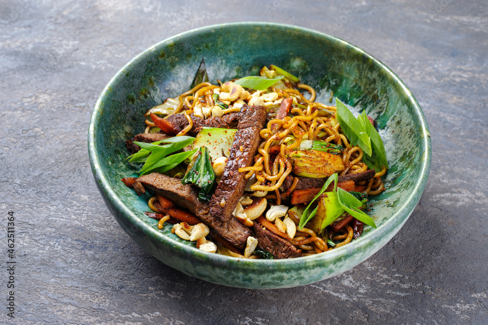 Modern style pad Thai beef with angus roast beef slices, noodles and vegetable served as close-up in a Nordic design bowl Modern style pad Thai beef with angus roast beef slices, noodles and vegetable served as close-up in a Nordic design bowl