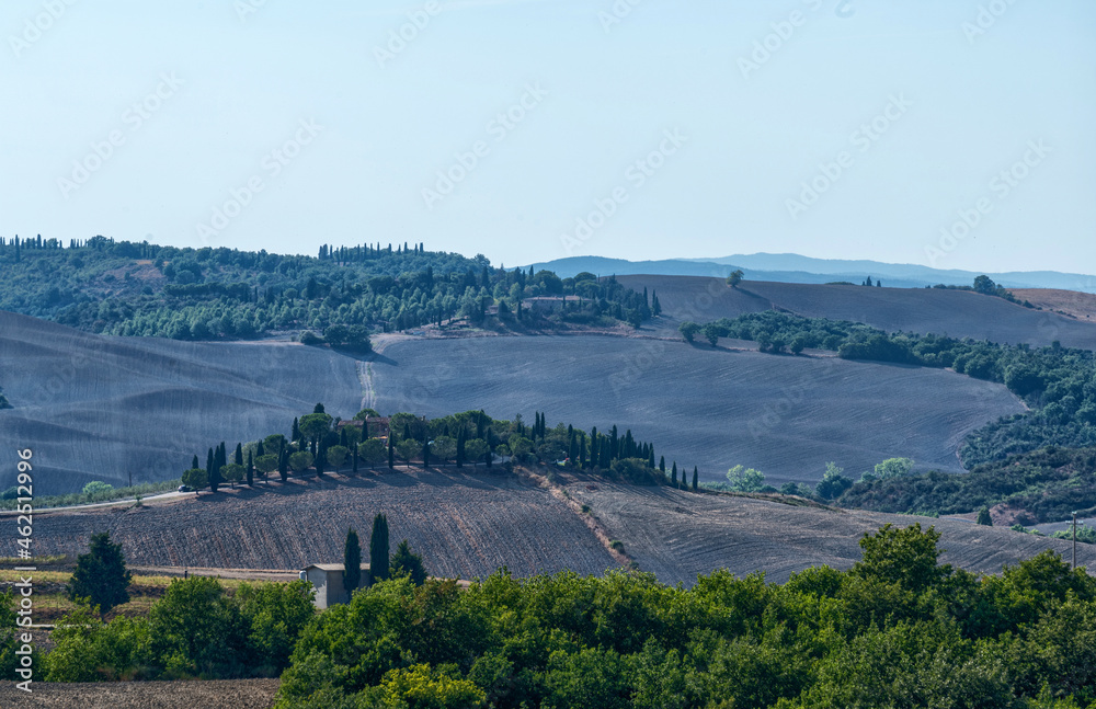 Tuscany, Italy. August 2020. Amazing landscape of the Tuscan countryside with the typical rolling hills and cypresses to mark the boundaries.