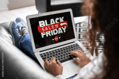 Young woman shopping online on Black Friday at home