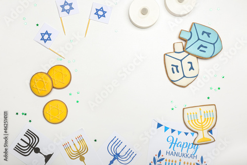 Frame made of different symbols of Hanukkah on white background