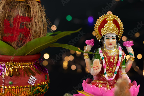 Beautiful Statue Of Maa Mata Lakshmi Laxmi Devi With Clay Kalash And Bokeh Effect. Theme For Diwali Puja , New Year, Deepawali Pooja Or Shubh Deepavali