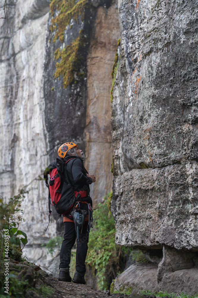 Old man climber on the mountain