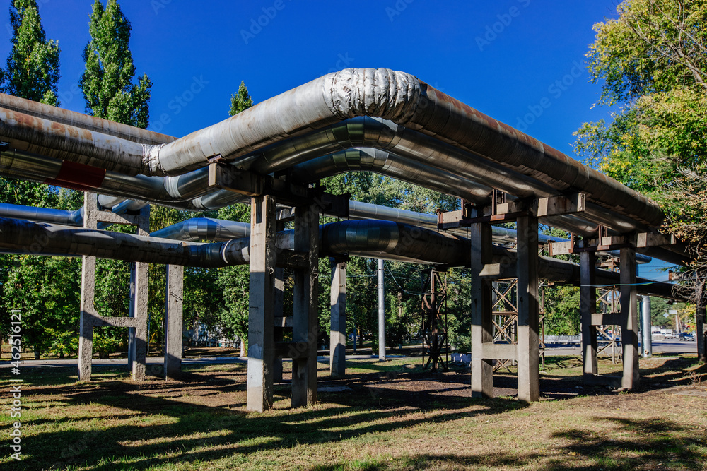 Steel pipelines outgoing from the plant at sunny day Steel pipelines outgoing from the plant at sunny day