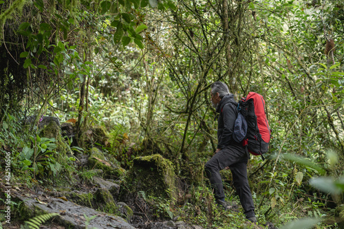 Old man climber on the mountain