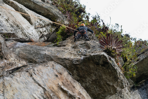 Old man climber on the mountain