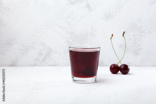 Ginjinha or Ginja - Portuguese liqueur made by infusing ginja berries (sour cherry, Prunus cerasus austera, Morello cherry) in alcohol (aguardente) and adding sugar photo